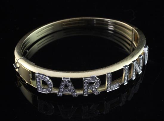 A gold and diamond Darling hinged bangle, gross weight 36 grams.